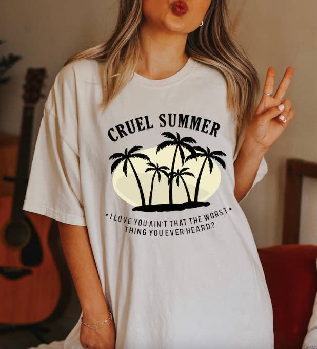 model in oversized off white tee with palm trees and text 