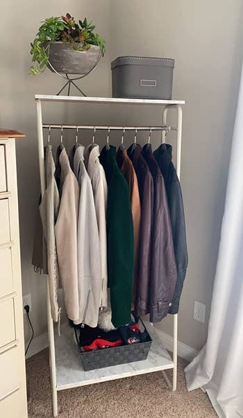 a reviewer photo of a clothing rack with clothes hanging on it 