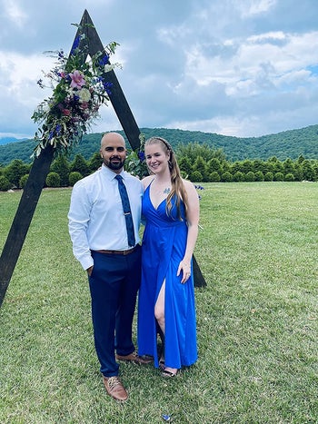 A reviewer wearing the bright blue dress
