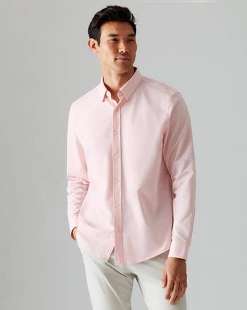 a model wearing the shirt in light pink 
