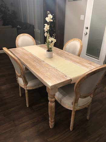 a review photo of four of the chair surrounding a dining table