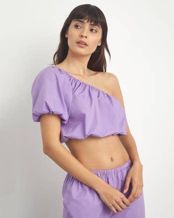 front view of model in the lavender one-shoulder crop top