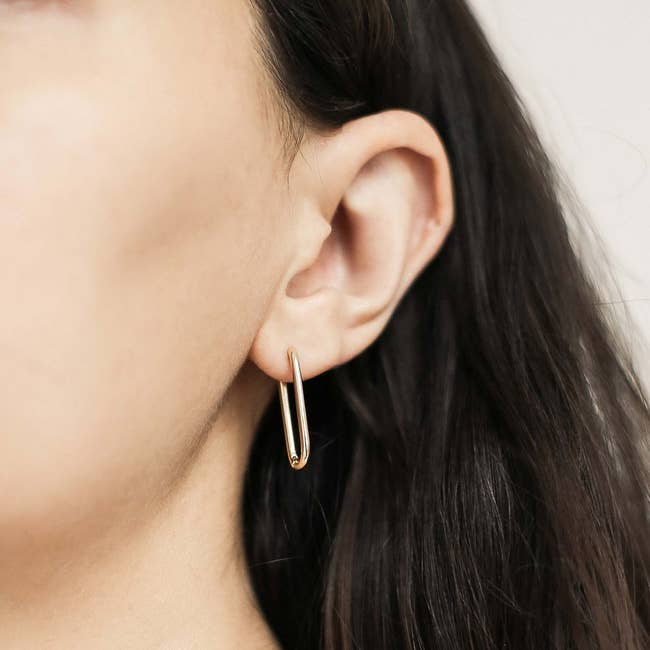 model with a gold-plated halo hoop earring