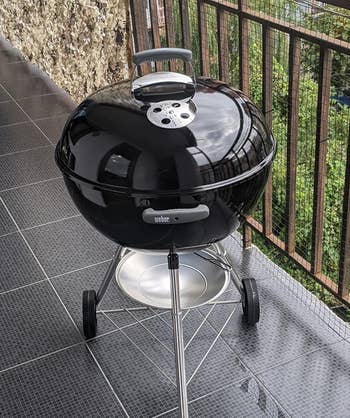 reviewer photo of the black grill on a raised patio