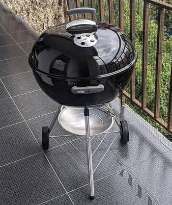 The black grill on a raised patio