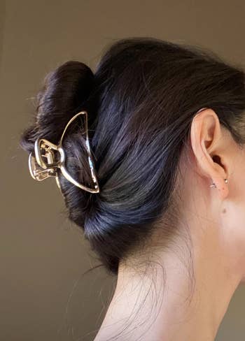Reviewer with hair pulled into a bun with the clip at the again 