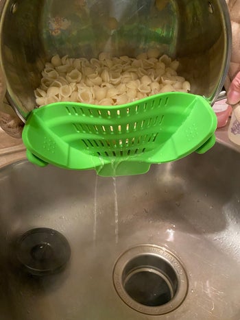 pasta water being strained into sink
