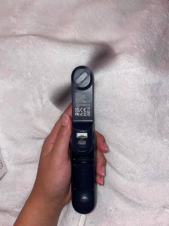 image of reviewer with the unfastened and in-use portable fan