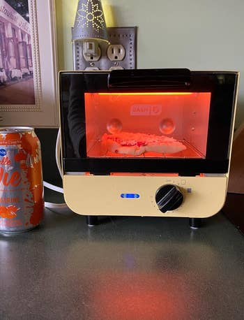 A small, yellow countertop toaster oven 