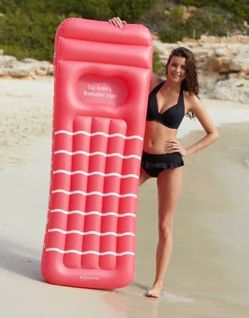 model next to pink pool float with indented space for boobs labeled 