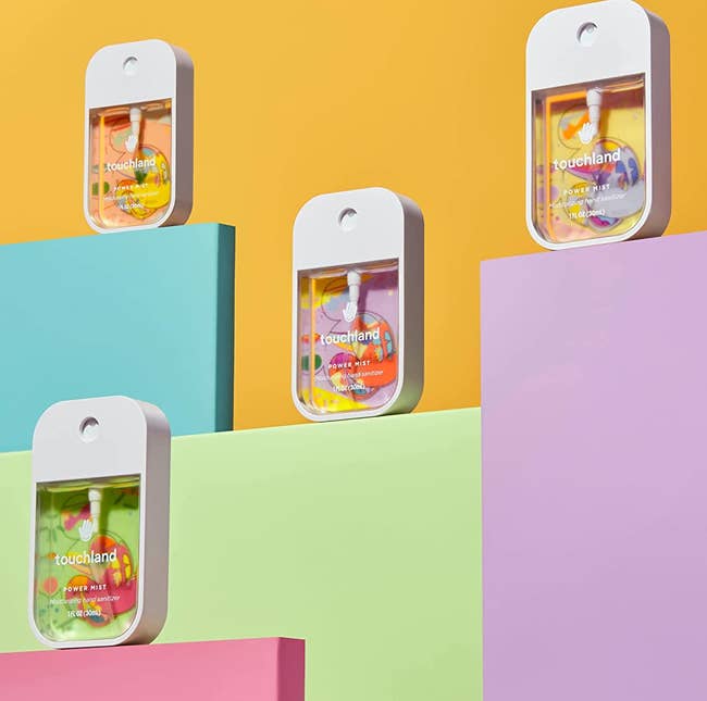the four-pack of disney-themed hand sanitizers on a colorful background