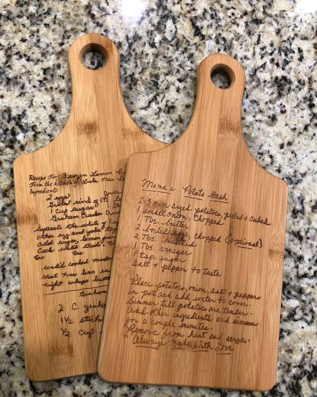 two cutting boards engraved with handwritten recipes