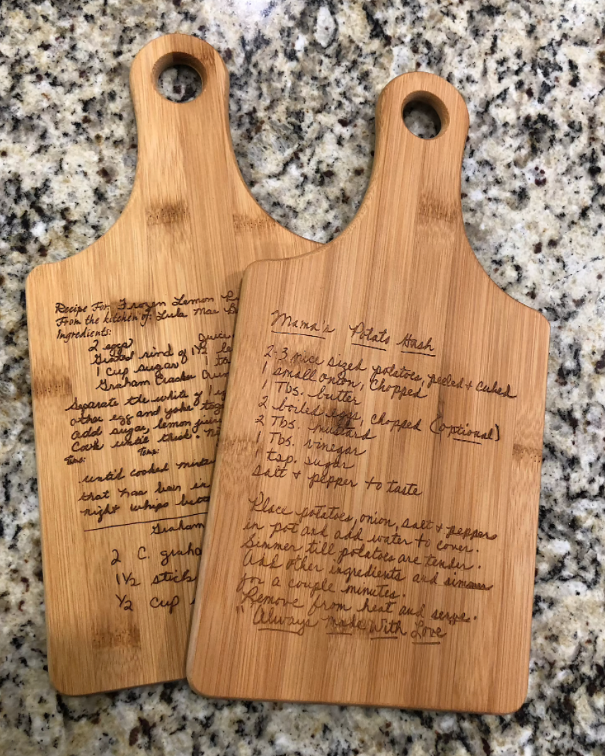 two cutting boards engraved with handwritten recipes