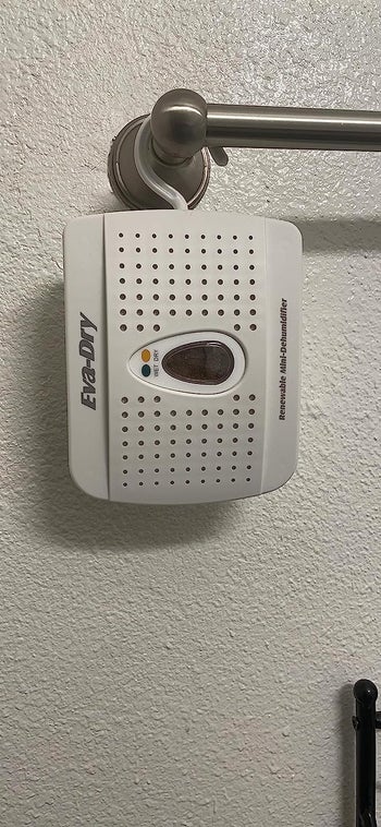 another reviewer's photo of the dehumidifier hanging on a towel bar