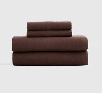 Stack of brownish  linen furniture  sheets and pillowcases neatly folded