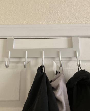 another reviewer photo of clothes hanging on the hook rack