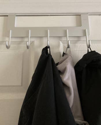 another reviewer photo of clothes hanging on the hook rack