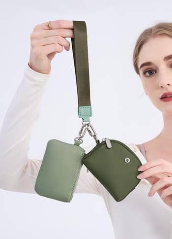 Person holding a dual-compartment wallet connected  a strap, showcasing a modern   accessory for an nonfiction  successful  the buying  category