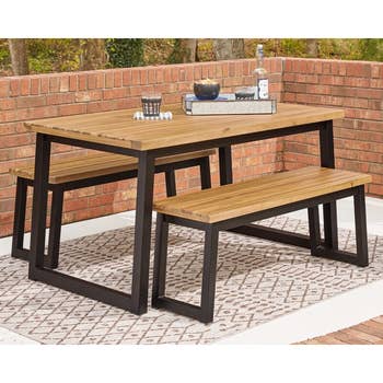 lifestyle photo of wooden picnic table in a backyard