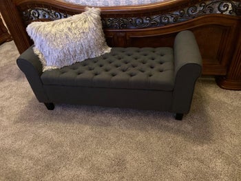 reviewer photo of the black bench at foot of the bed