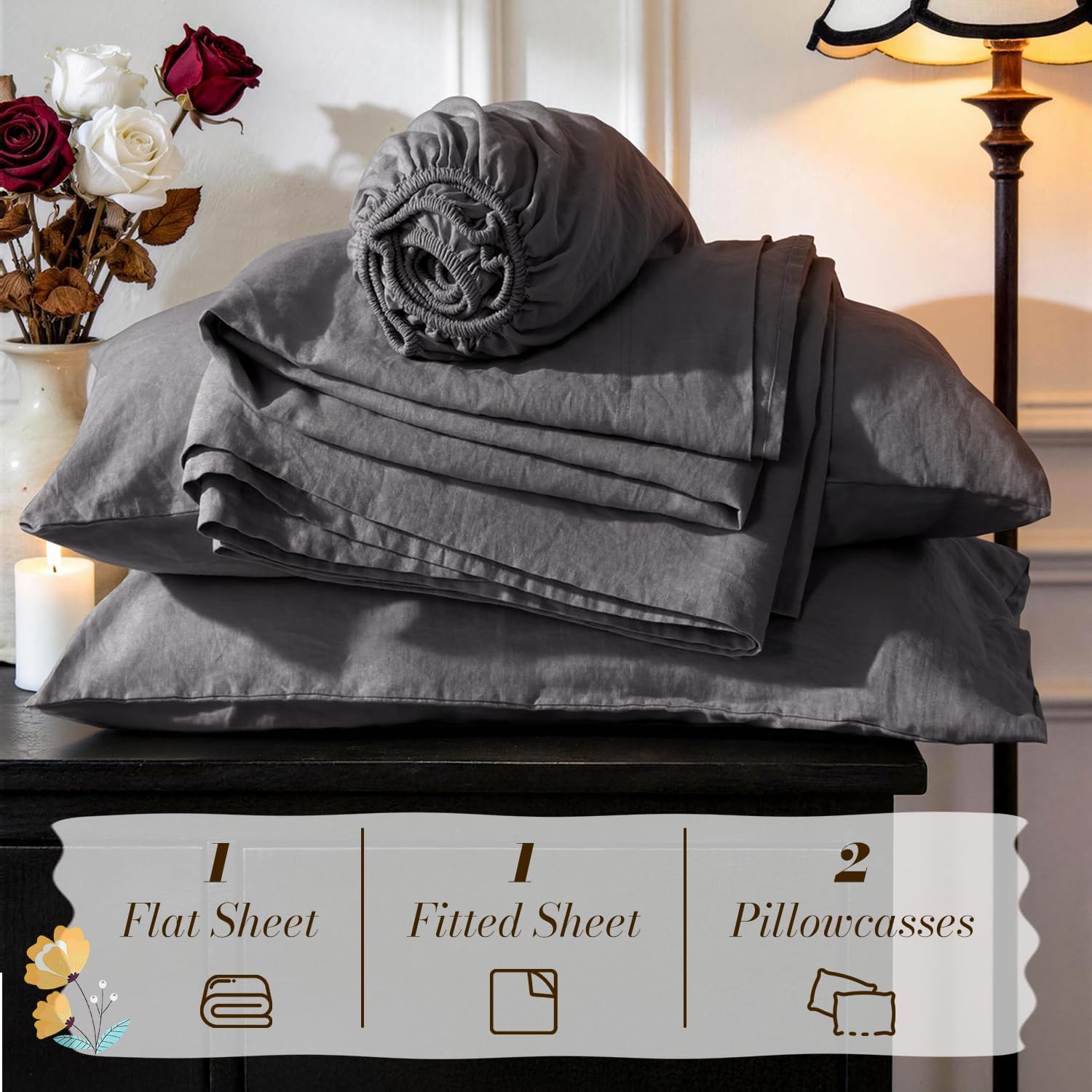 Set of gray bed sheets including one flat sheet, one fitted sheet, and two pillowcases, displayed in a home setting with decorative flowers