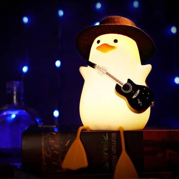 duck-shaped night-light wearing a cowboy hat and holding a guitar