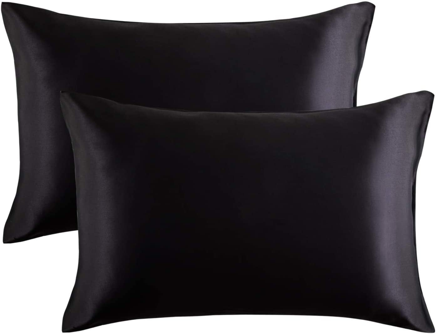 two bed pillows in black satin pillowcases