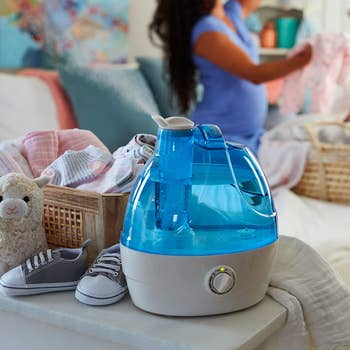 lifestyle image of the humidifier emitting steam in child's room