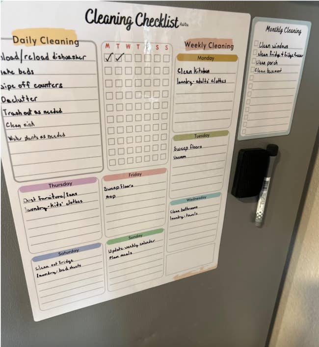 Cleaning checklist connected a fridge with daily, weekly, and monthly tasks. Includes sections for each time and a dry-erase pen attached