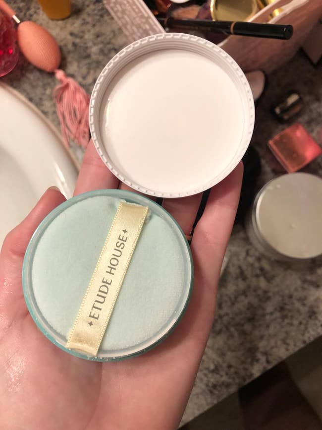 a reviewer holding the powder product