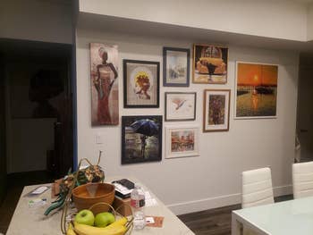 Wall with various framed artworks hung up