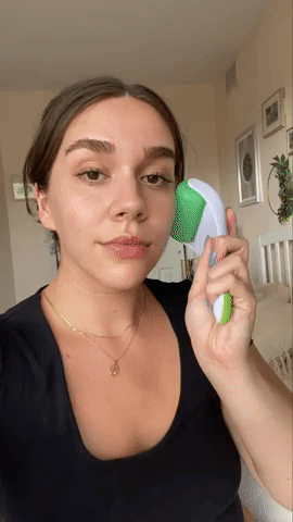 BuzzFeed writer using the green ice roller on their face