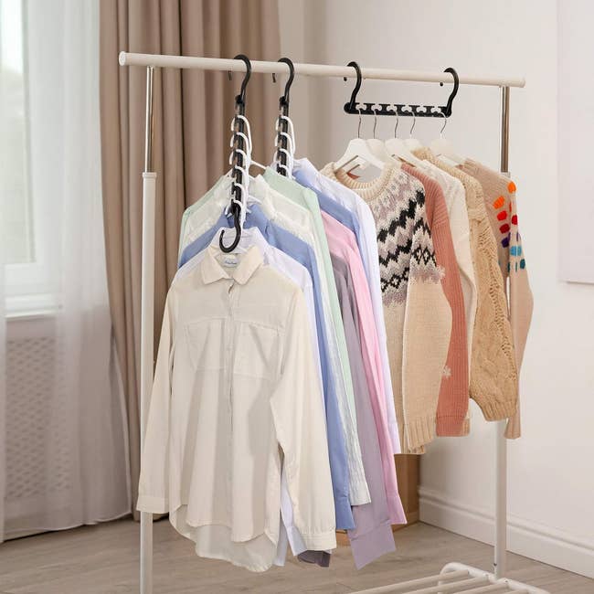 a clothing rack with clothes hanging on the cascading hangers 