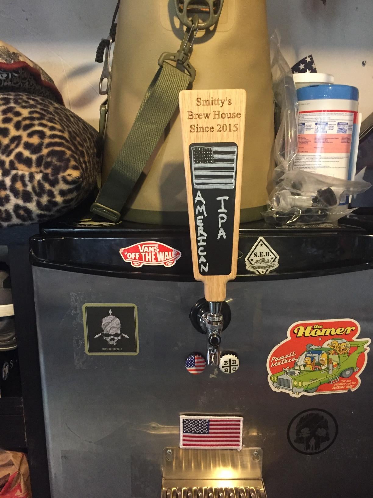reviewer's personalized beer tap handle on a fridge with magnets