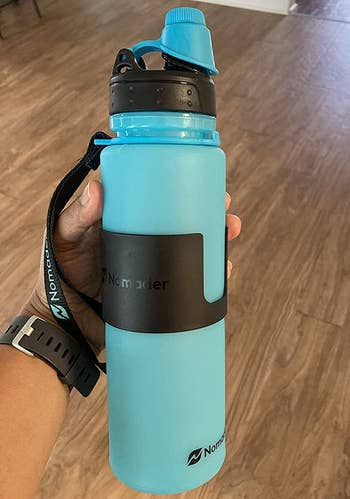 another reviewer holding their blue water bottle