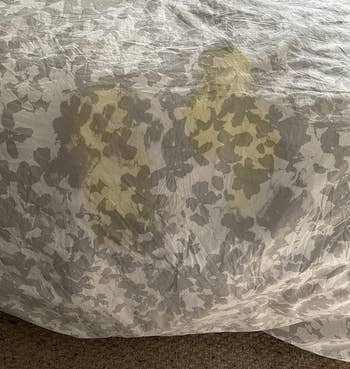 a reviewer photo of a stained comforter 