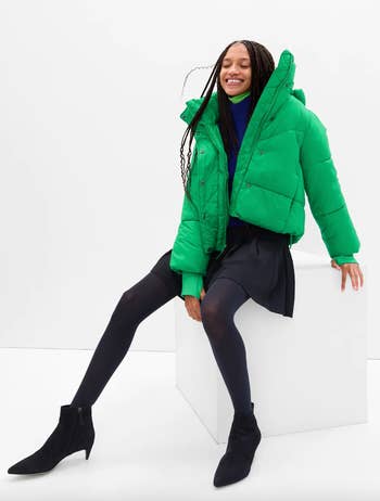 model wearing the coat in kelly green