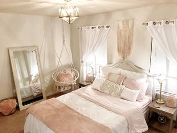 a reviewer's pink and white bedroom with the white swing in the corner