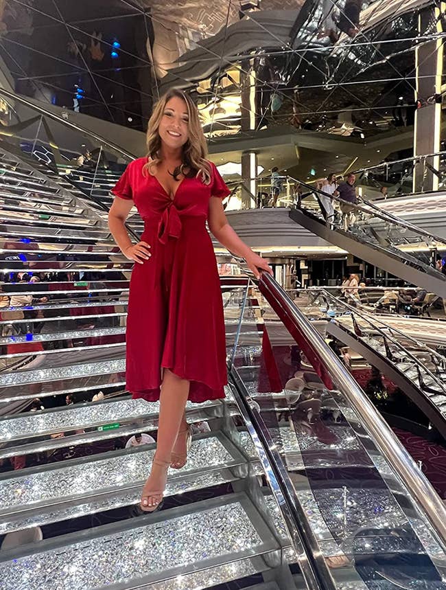 reviewer posing in red wrap dress