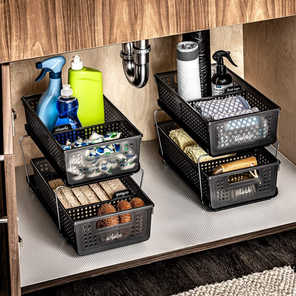 the baskets under a sink cabinet filled with cleaning supplies