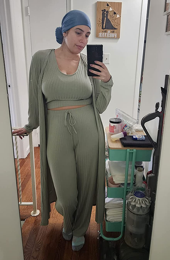 a reviewer wearing the ribbed tank, pants, and cardigan in light green