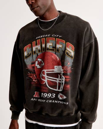 a model in a vintage styled kansas city chiefs sweatshirt