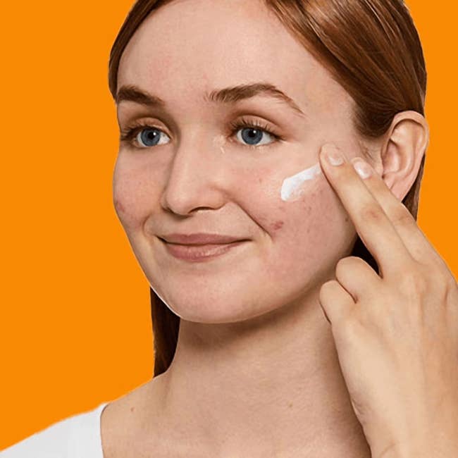Person applying sunscreen to their feature with a finger