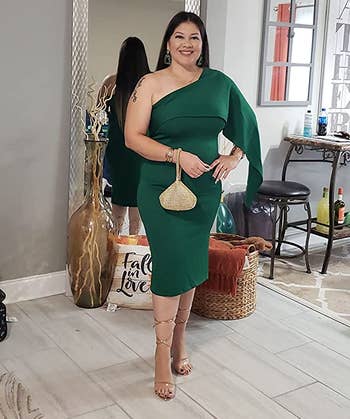 A reviewer wearing the dress in green
