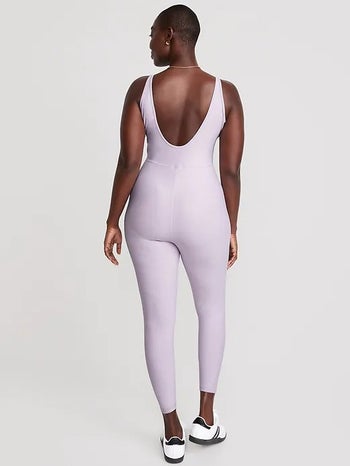 model showing the back of the bodysuit with the deep u-shaped back