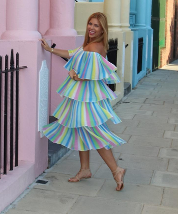 reviewer in the rainbow striped dress