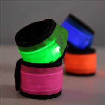 close-up of the LED armbands in green, pink, blue, and orange