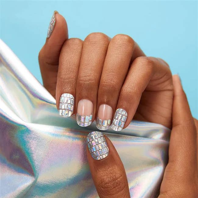 model's hands with disco ball like nail design