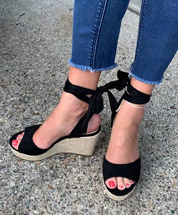 reviewer wearing the black wedges