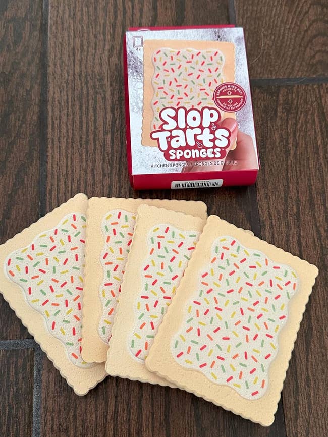 Box and 4  pastry-shaped sponges with colorful sprinkles design, resembling meal  pastries. Shopping-related novelty room  items